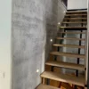 XSTONE Wall - 034 Veneer Travertine grey on the wall of a staircase